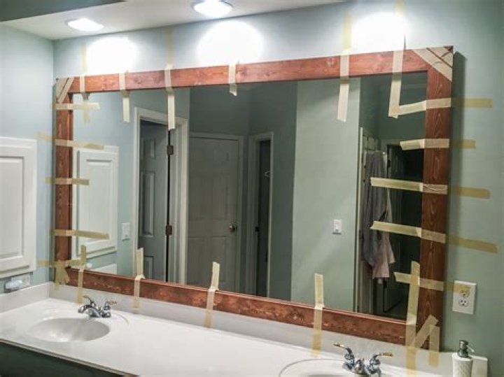 How do you glue a bathroom mirror to the wall?