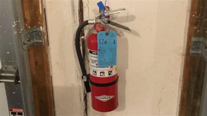 How do you mount a fire extinguisher on the wall?
