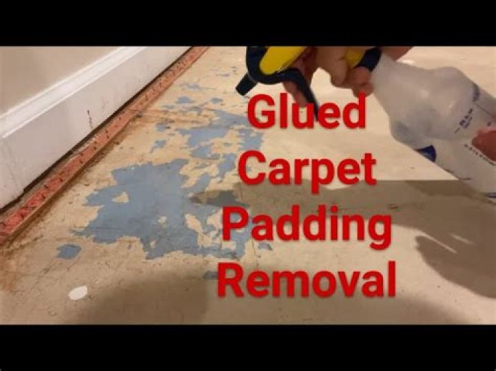 How do you remove stuck carpet padding from a concrete floor?