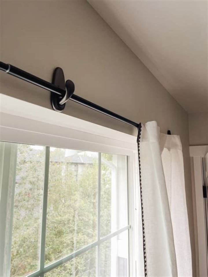 Where do you hang curtain tracks?