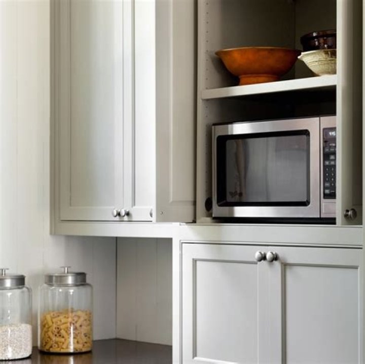 Where should a microwave be placed in a small kitchen?